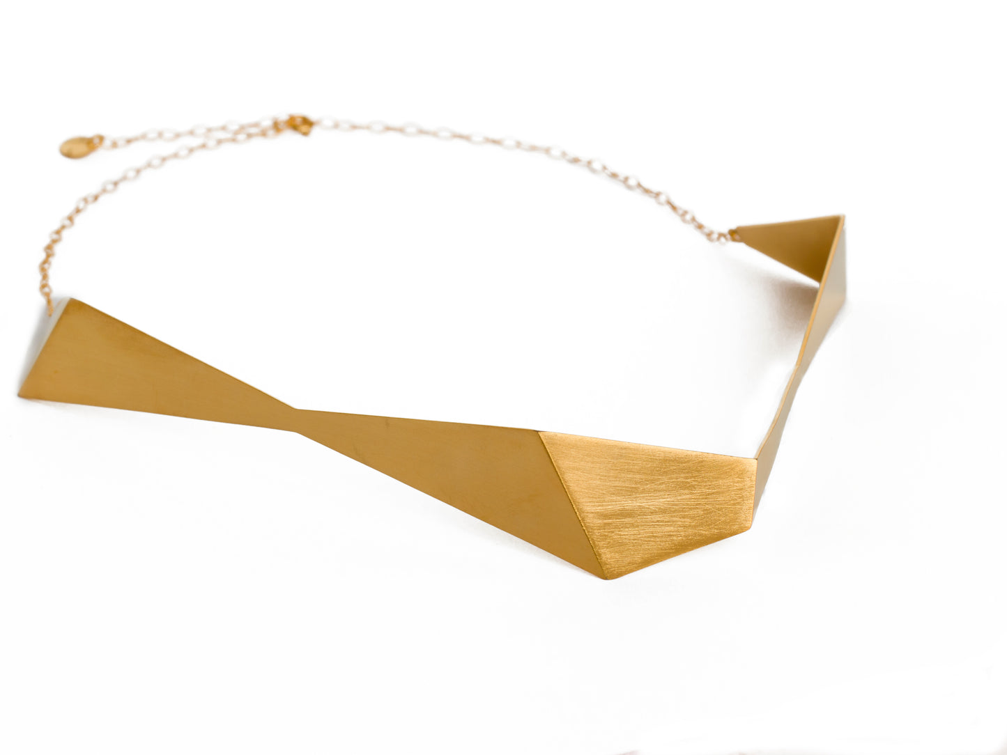 Geometric sculptural gold chocker necklace from folded metal sheet and gold chain
