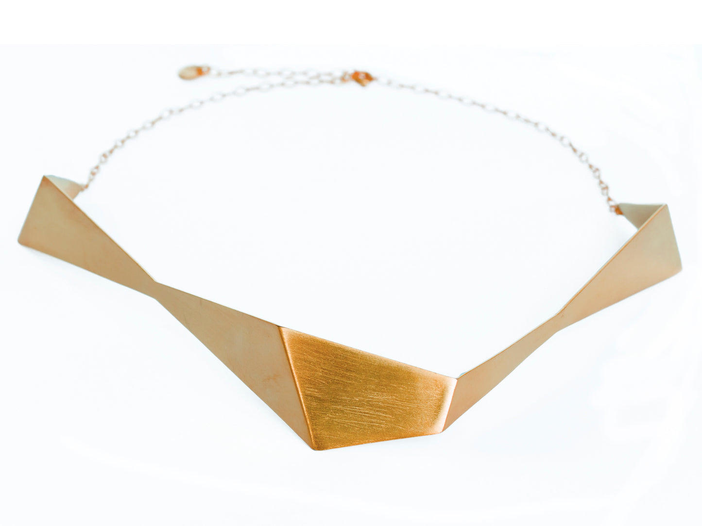 Geometric sculptural gold chocker necklace from folded metal sheet and gold chain