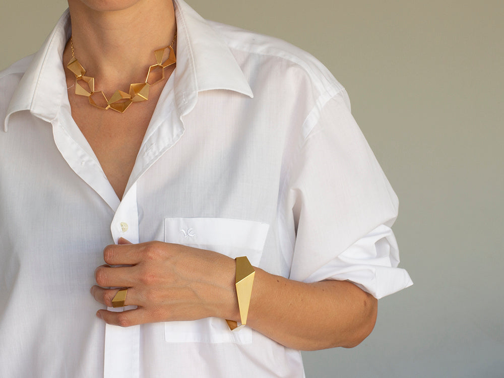 geometric architectural jewelry for simple outfit