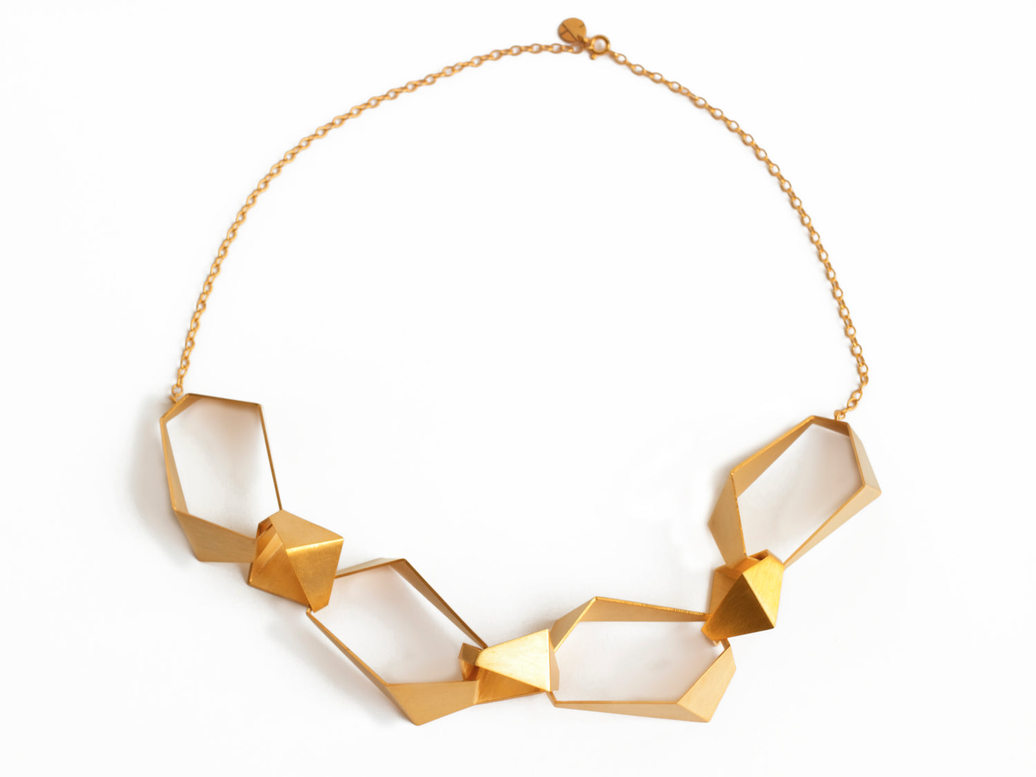 Geometric chunky link statement necklace made of 7 geometric links and gold chain