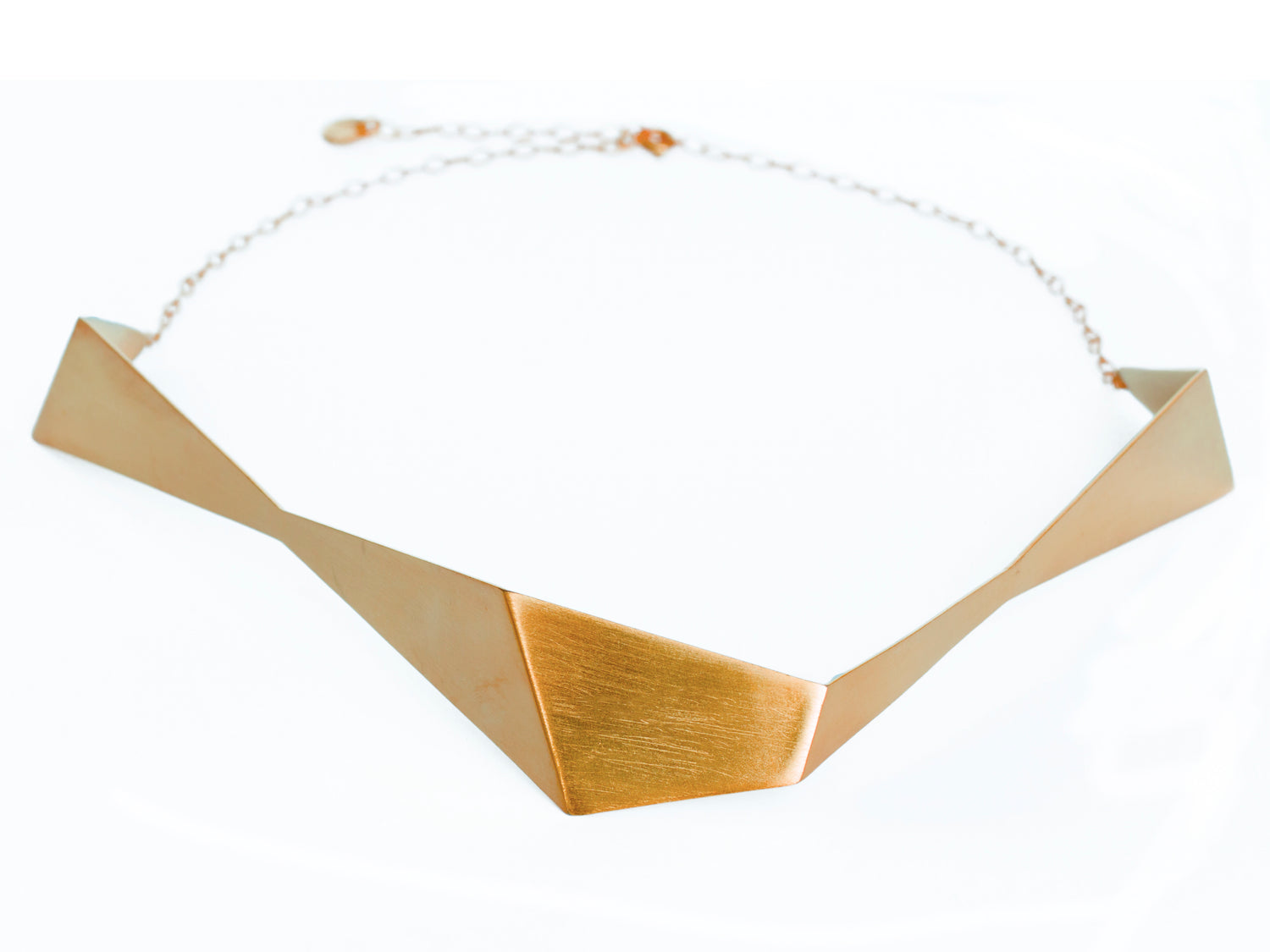 Geometric sculptural gold chocker necklace from folded metal sheet and gold chain