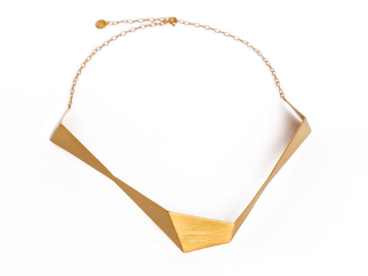 Geometric sculptural gold chocker necklace from folded metal sheet and gold chain