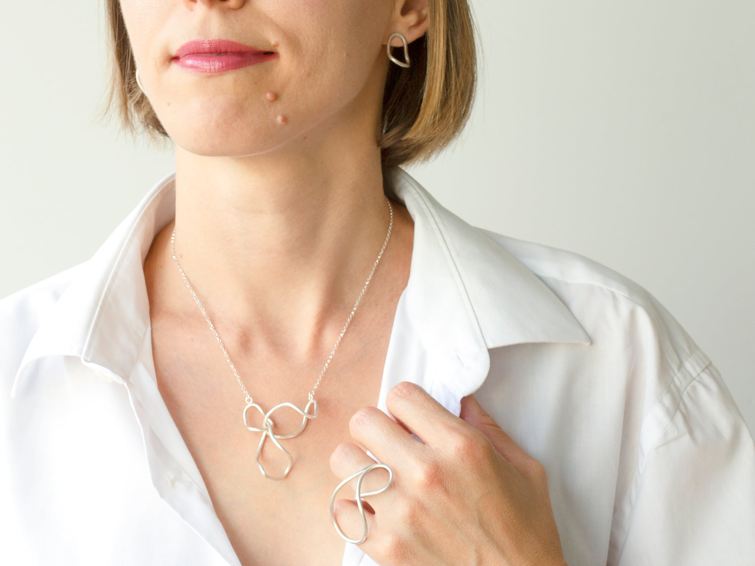 A model with sterling silver organic shaped necklace and statement sterling silver ring