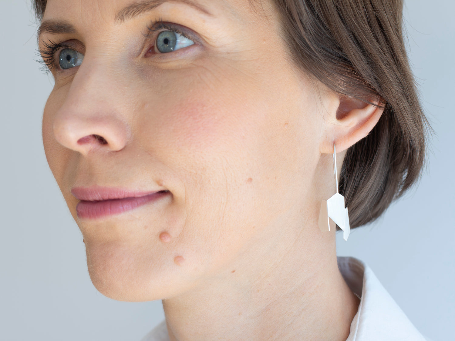 A woman with sterling silver drop earrings