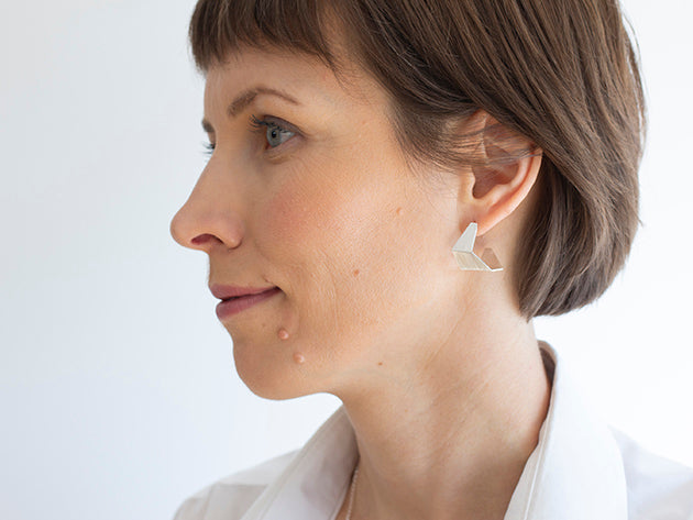 Woman wearing silver earrings